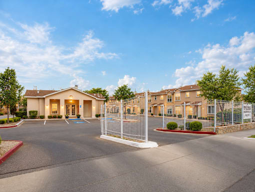 A gated community with a large building in the background.