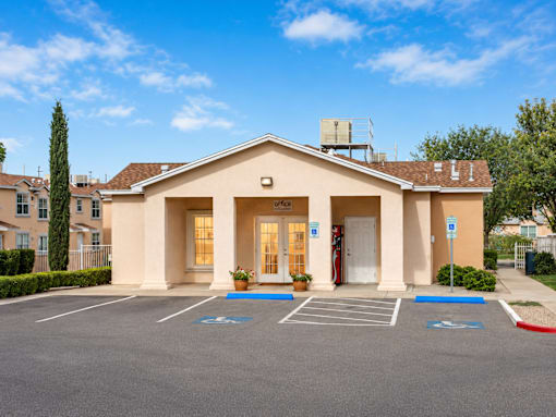 A building with a parking lot in front of it.