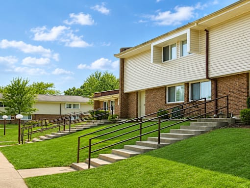A building with a staircase leading to the front door.