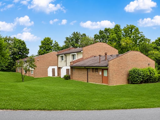 A house with a brown roof and a white garage door.