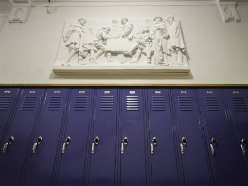 A row of purple lockers with a white marble frieze above.