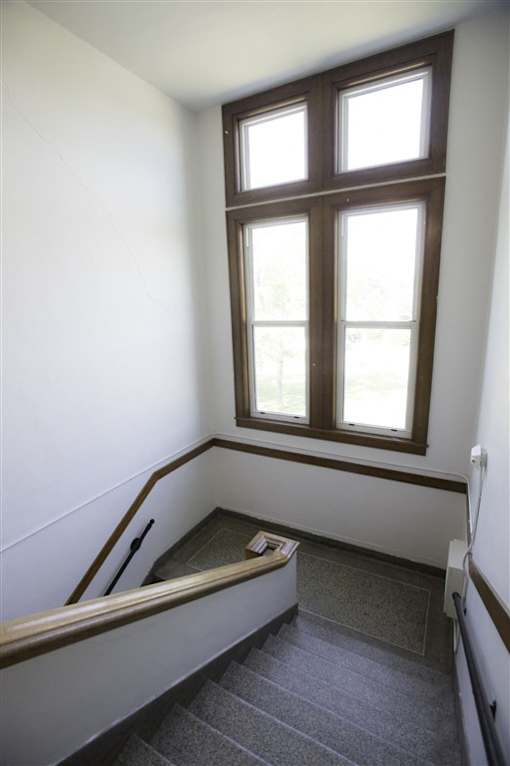 A stairway with a window above it.