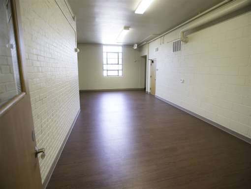 A long hallway with a door at the end.