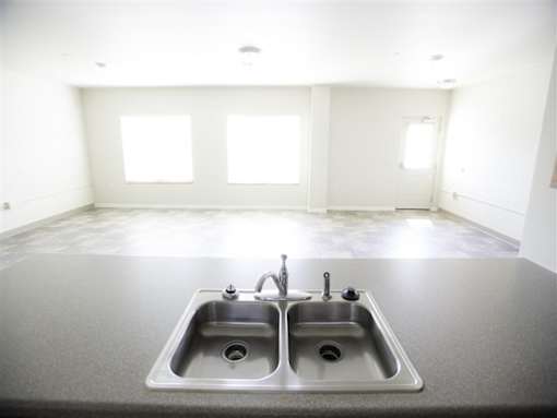 A kitchen with a double sink and a window.