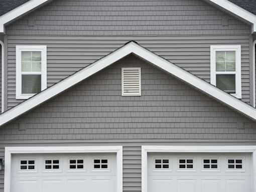 A house with two white garage doors.