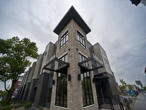 A modern building with a stone facade and large windows.