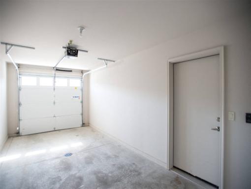 A room with a white door and a window with blinds.