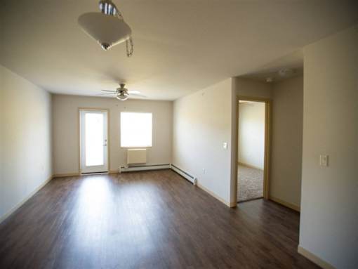 A room with a ceiling fan and a window.