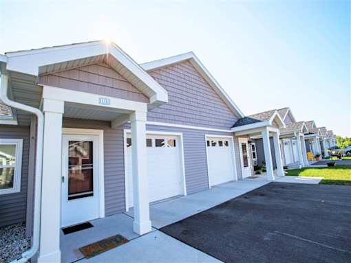 A row of houses with garages in front.