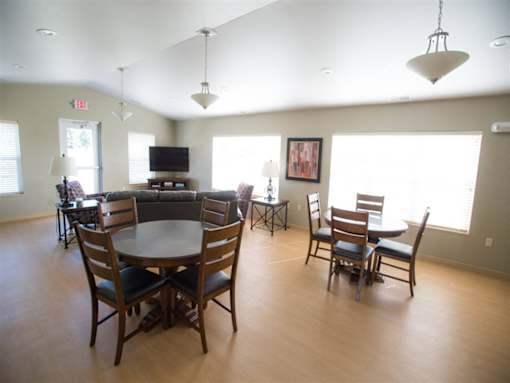A large room with a table and chairs.