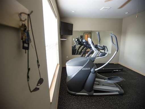A home gym with a treadmill and exercise bike.