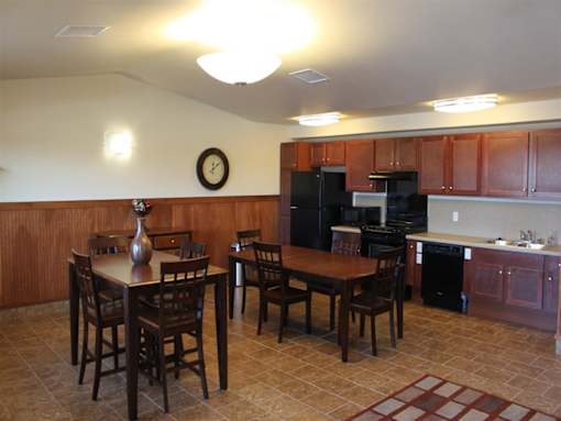 A kitchen with a table and chairs in the middle of the room.