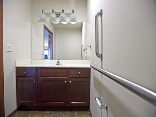 A bathroom with a sink and a mirror.