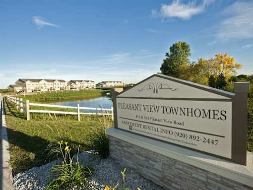 A sign for Pleasant View Townhomes with a phone number for renting.