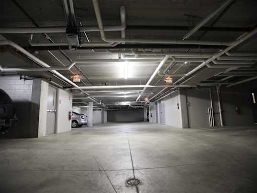A car is parked in a dimly lit parking garage.