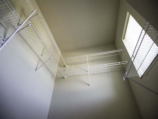 A white shelving unit is mounted on the wall.