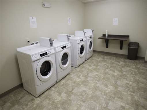 A row of washing machines in a laundromat.