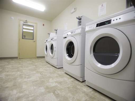 A row of washing machines in a laundromat.
