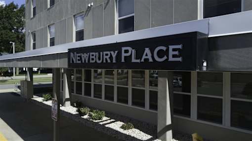 A building with a sign that says Newbury Place.