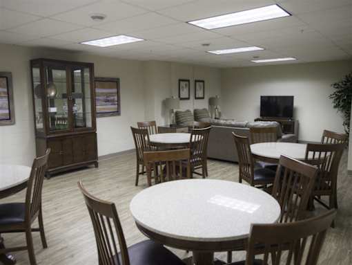 A conference room with a table and chairs.