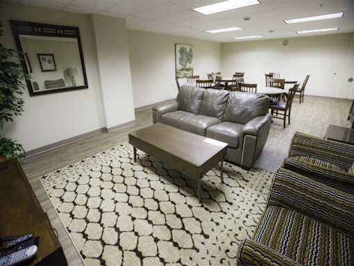 A living room with a black and white patterned rug.