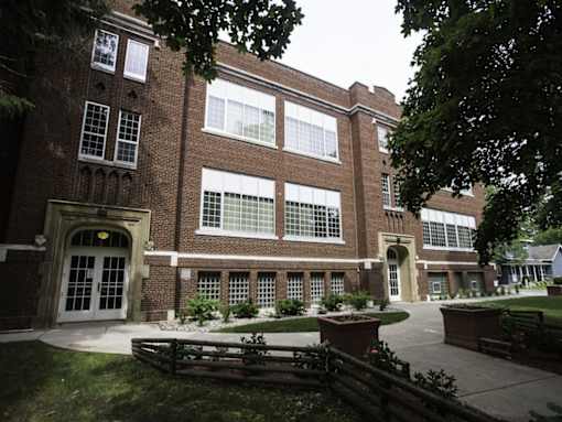 A large brick building with a white door and windows.