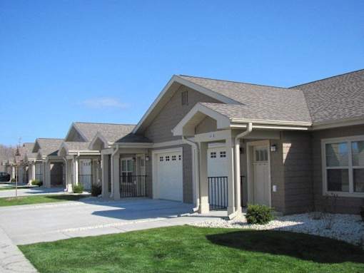 A row of houses with a clear blue sky above them.