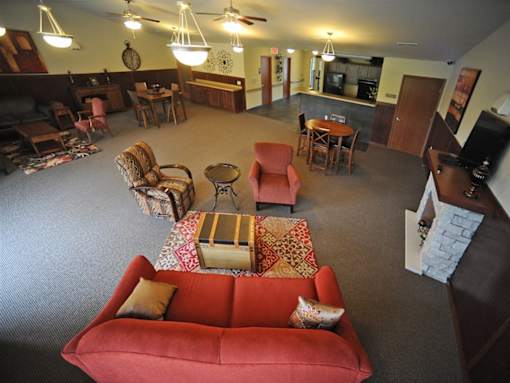 A living room with a red couch and a coffee table.