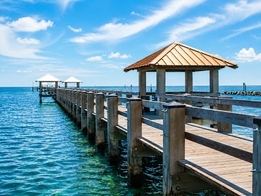 A wooden pier with a gazebo extends into the water.