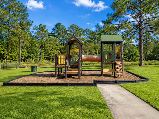 A playground with a slide and a wooden structure.