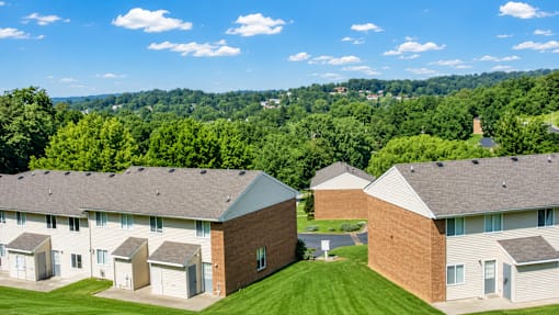 A group of houses with a green lawn in front.