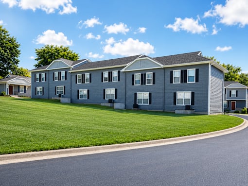 A row of houses with a road in front.
