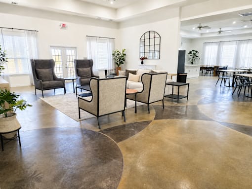 A living room with a circular concrete floor and a fireplace.