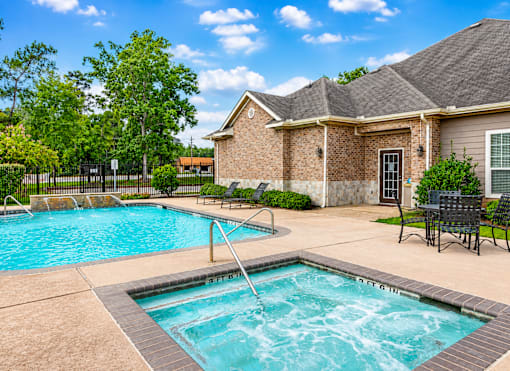 A swimming pool in front of a house.