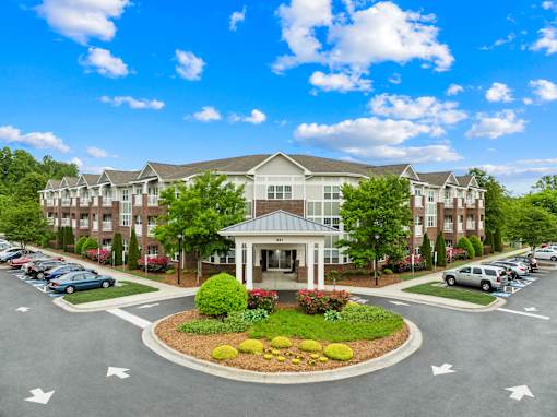 A large building with a parking lot in front of it.