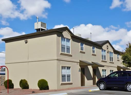 A building with a car parked in front of it.