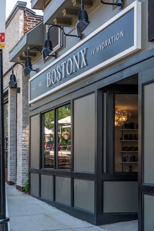 The Boston Hydration storefront is shown with a clear glass door and a sign above it.