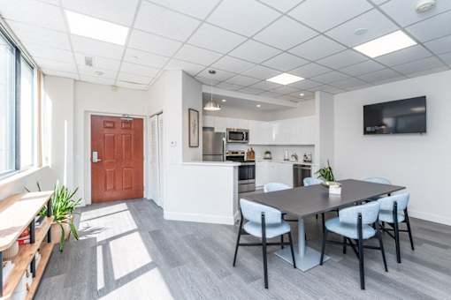 a dining room with a table and chairs and a kitchen