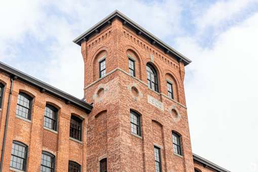 A red brick building with a tower and windows.