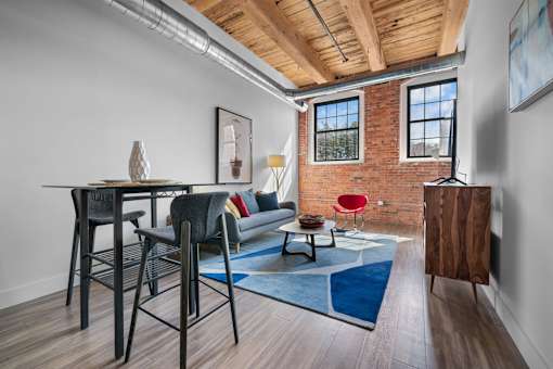 A room with a brick wall and a wooden ceiling.