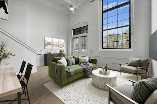 A living room with a green couch and a wooden table.