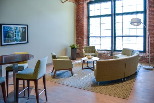 Living room with two chairs and couch at Mass Mills Apartments Lowell