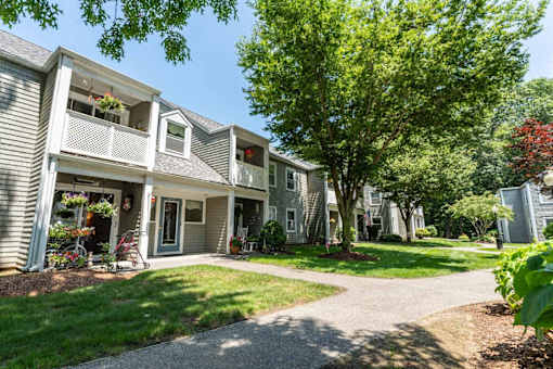 A sunny day at a residential area with apartment buildings and greenery.