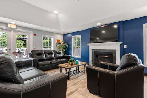 A living room with a fireplace and a television.