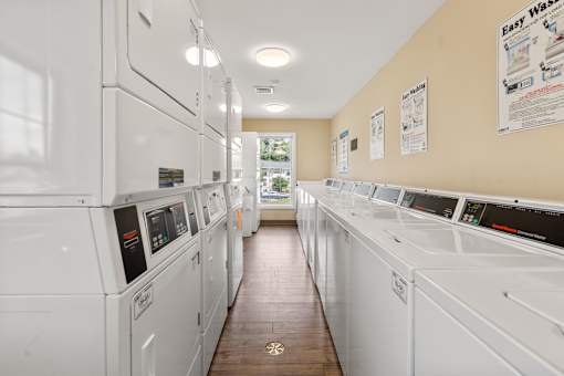 A laundromat with rows of washing machines.