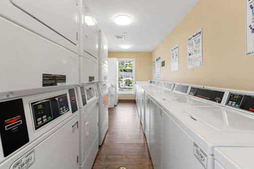 A row of washing machines in a public laundromat.