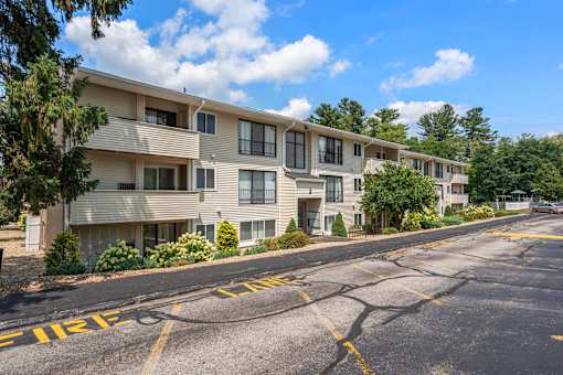 Apartment complex with a road in front of it.