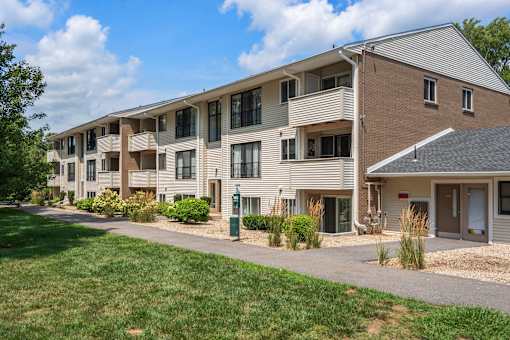 Apartment complex with a grassy area in front.