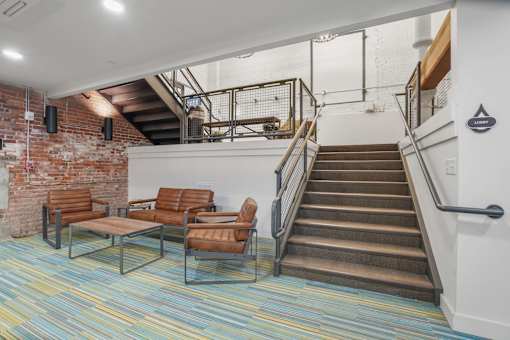 A staircase with a metal railing and a wooden handrail.