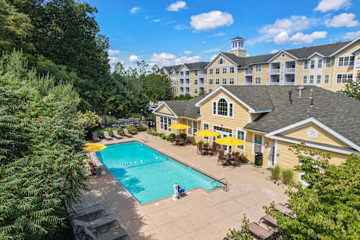 A large building with a pool in front of it.